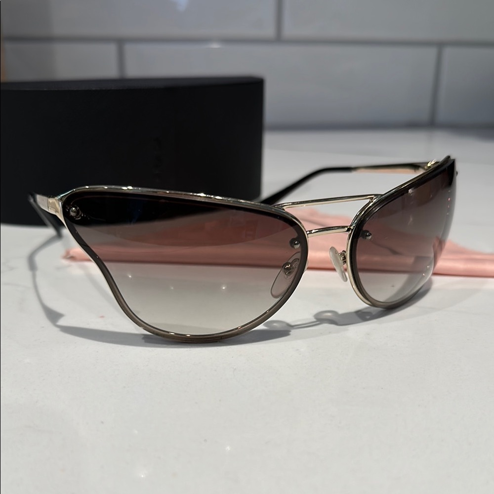 Prada PR74VS sunglasses butterfly silhouette with a metallic gold frame. - Picture 3 of 12